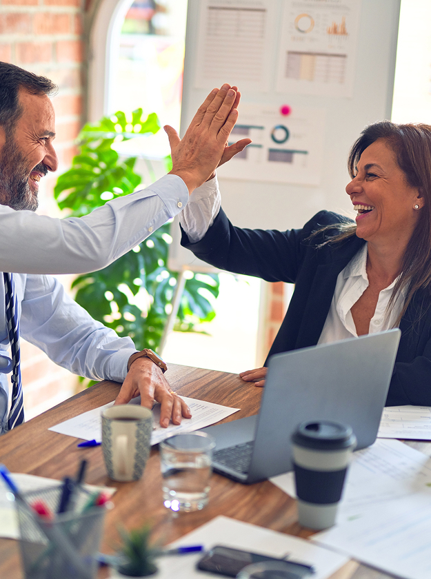Two employees high-fiving